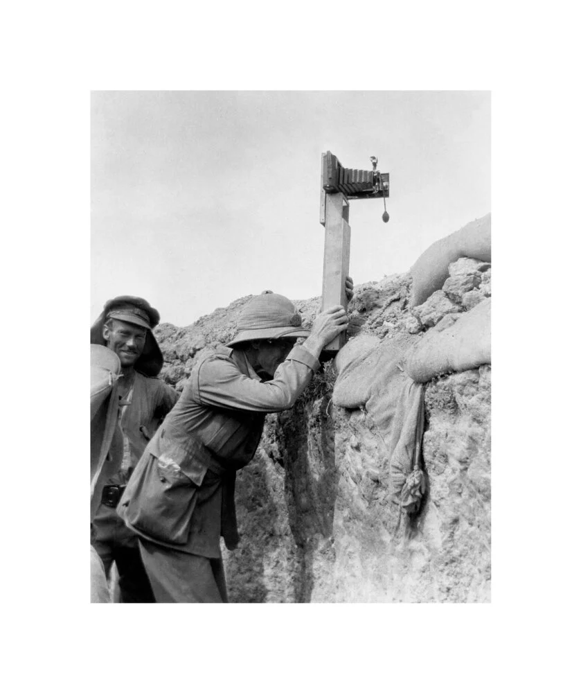 Soldier taking a photograph with a camera attached to a periscope, c 1915. - Image 27