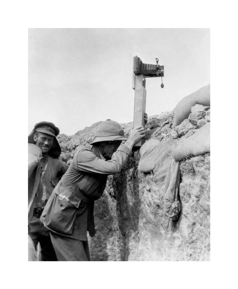 Soldier taking a photograph with a camera attached to a periscope, c 1915. - Image 28
