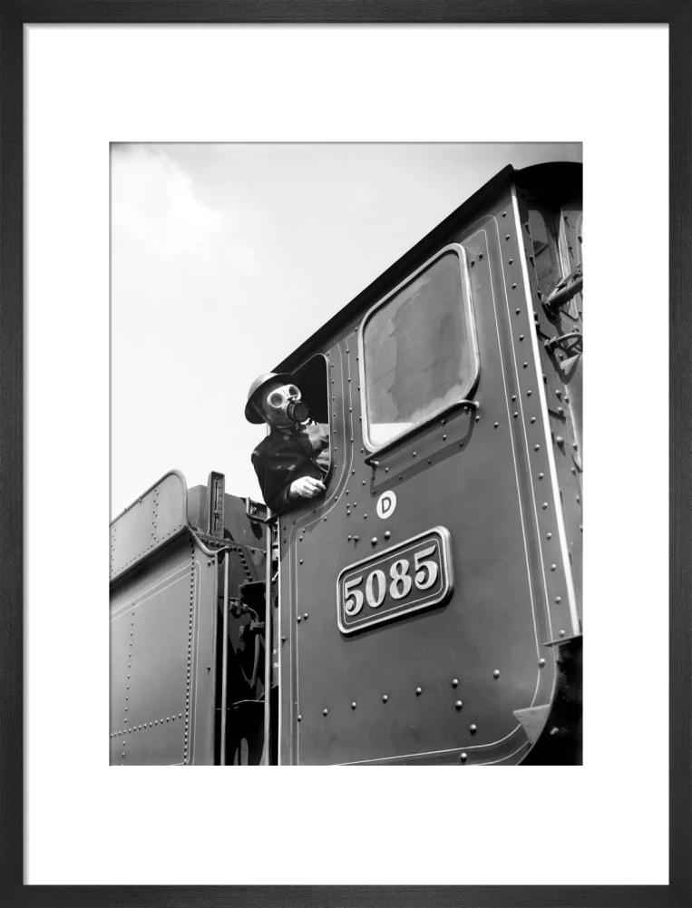 Train driver with a gas mask, World War Two, 21 August 1940. - Image 13