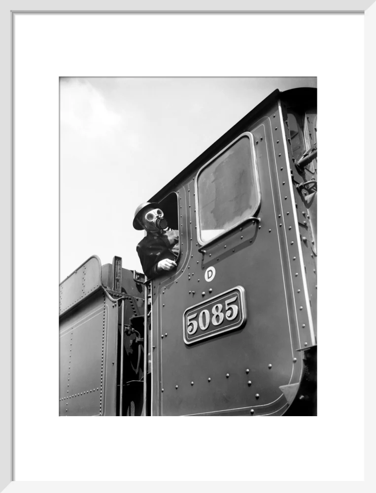 Train driver with a gas mask, World War Two, 21 August 1940. - Image 14