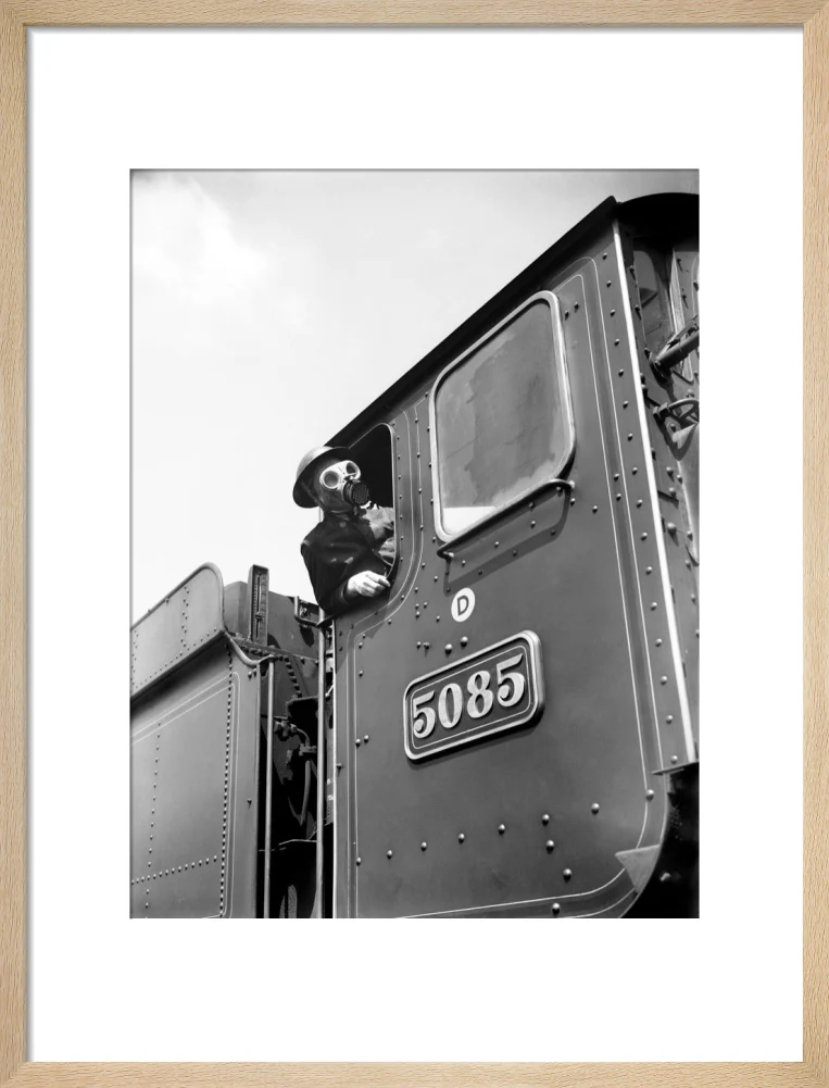 Train driver with a gas mask, World War Two, 21 August 1940. - Image 16