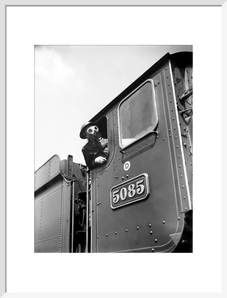 Train driver with a gas mask, World War Two, 21 August 1940. - Image 19