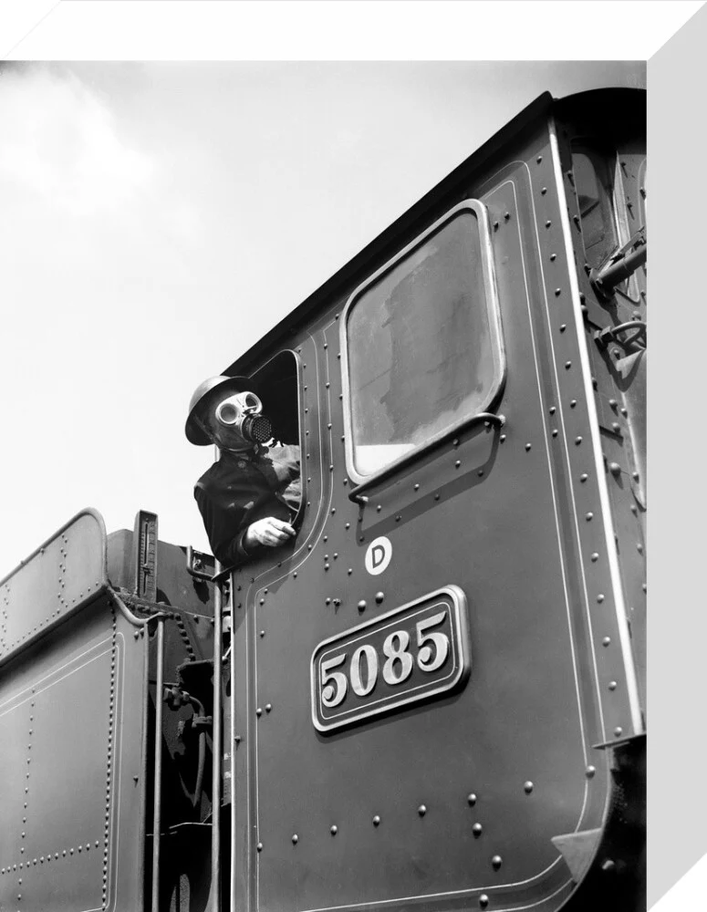 Train driver with a gas mask, World War Two, 21 August 1940. - Image 31