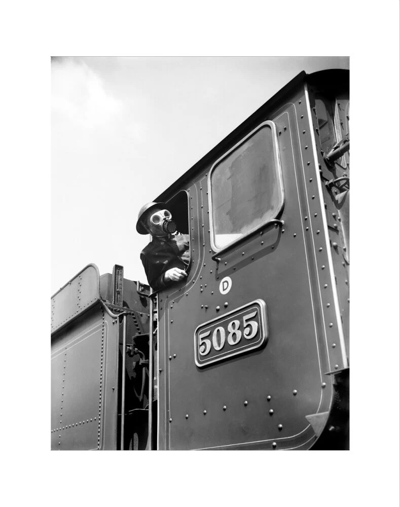 Train driver with a gas mask, World War Two, 21 August 1940. - Image 35