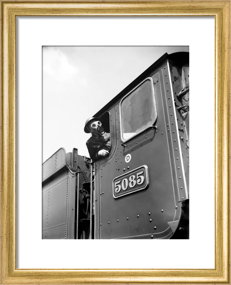 Train driver with a gas mask, World War Two, 21 August 1940. - Image 38