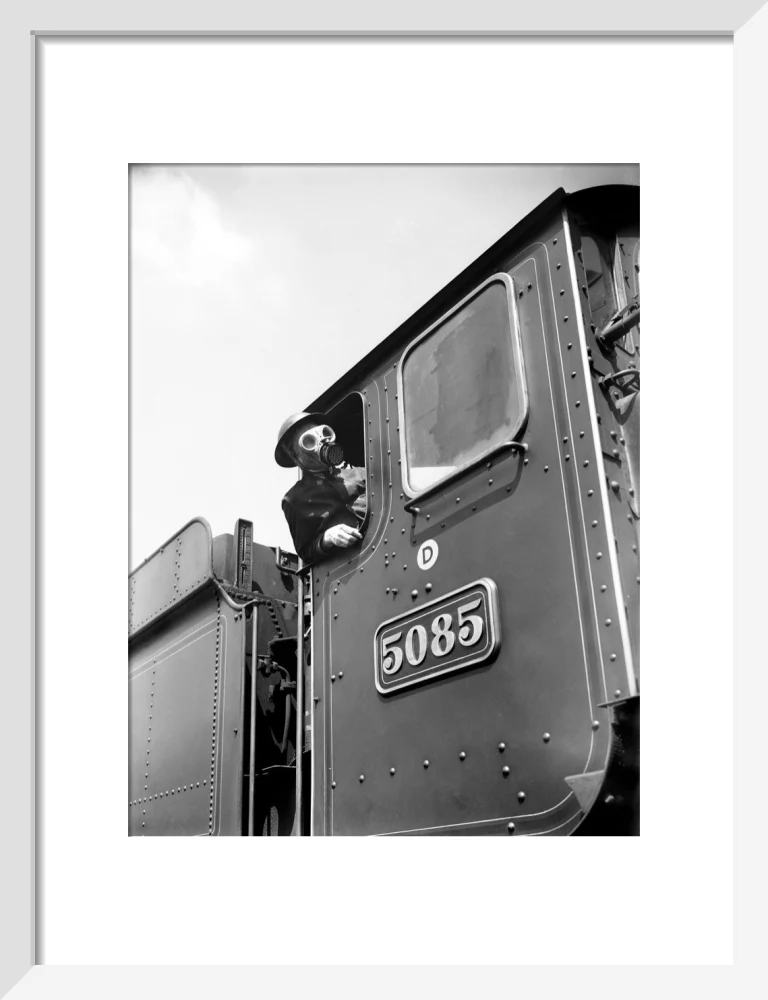 Train driver with a gas mask, World War Two, 21 August 1940. - Image 42