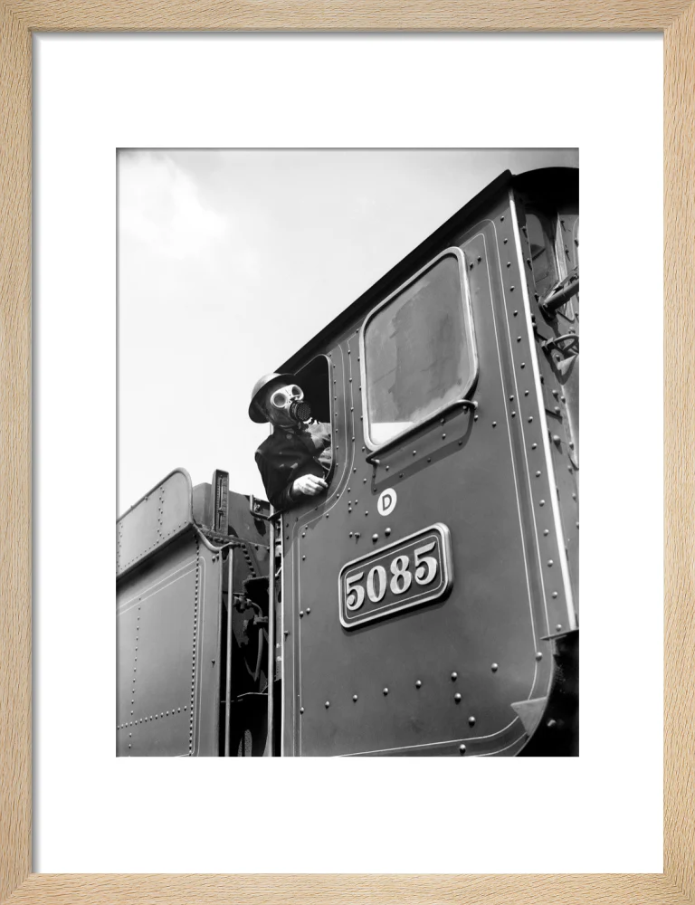 Train driver with a gas mask, World War Two, 21 August 1940. - Image 44