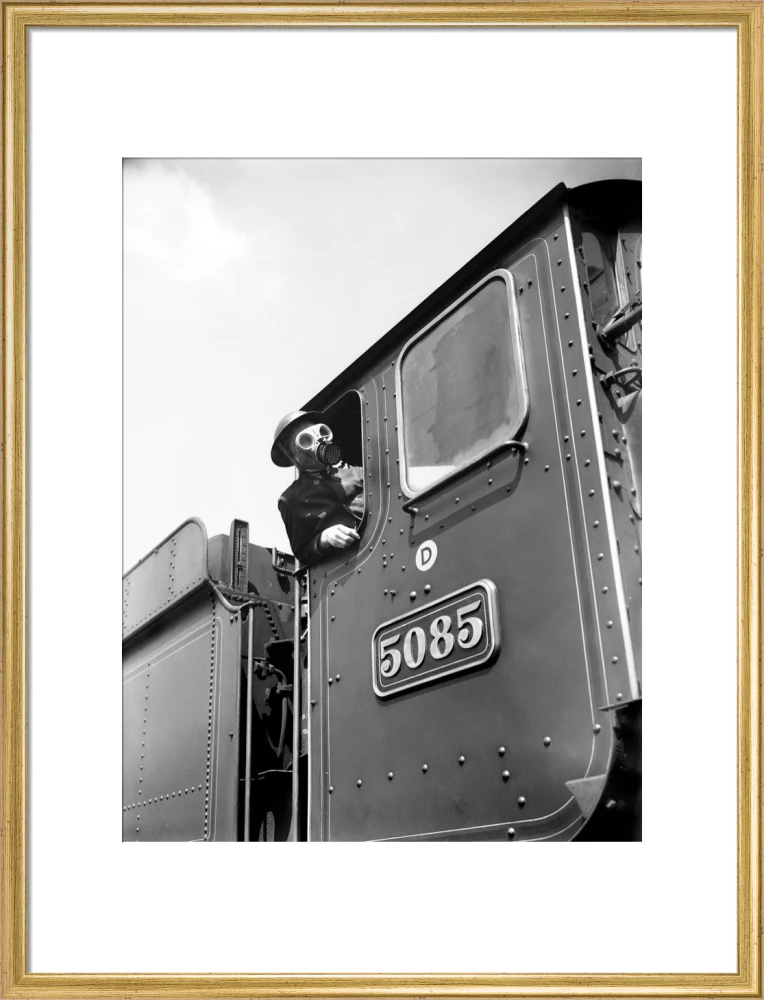 Train driver with a gas mask, World War Two, 21 August 1940. - Image 53