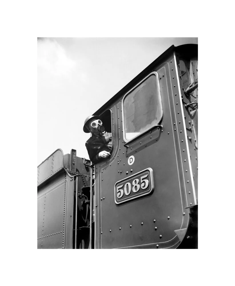 Train driver with a gas mask, World War Two, 21 August 1940. - Image 60