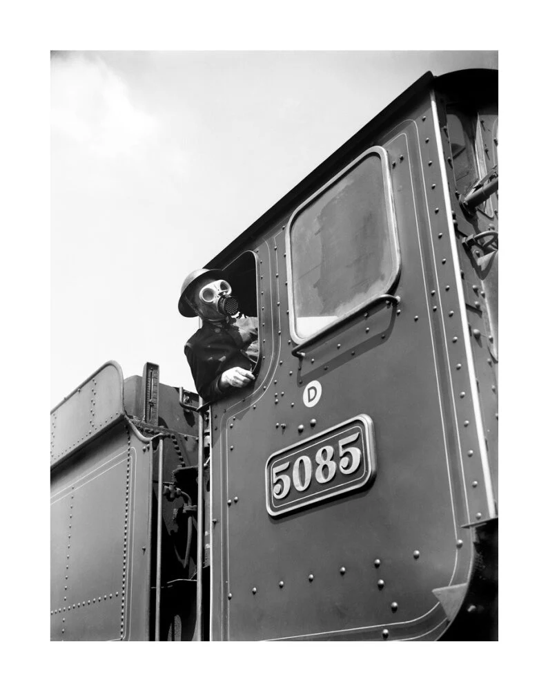 Train driver with a gas mask, World War Two, 21 August 1940. - Image 62