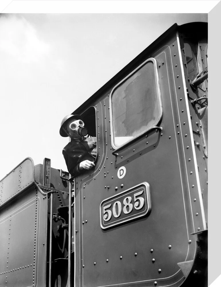 Train driver with a gas mask, World War Two, 21 August 1940. - Image 65