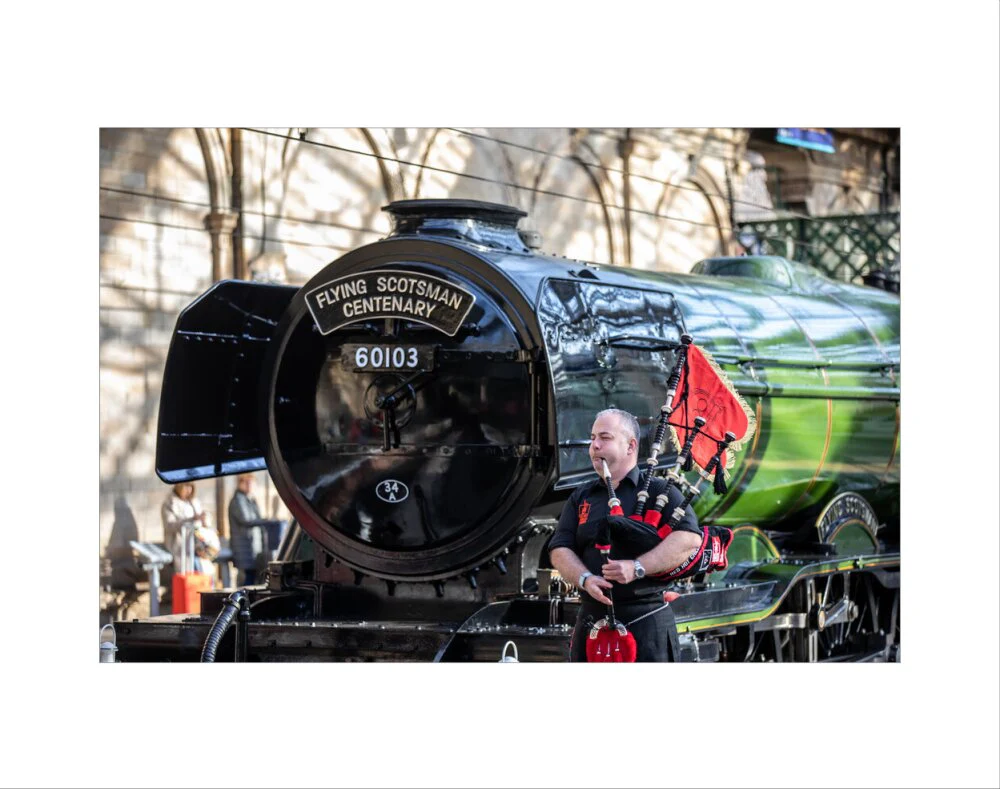 Kevin MacDonald from the Red Hot Chilli Pipers beside Flying Scotsman. - Image 2