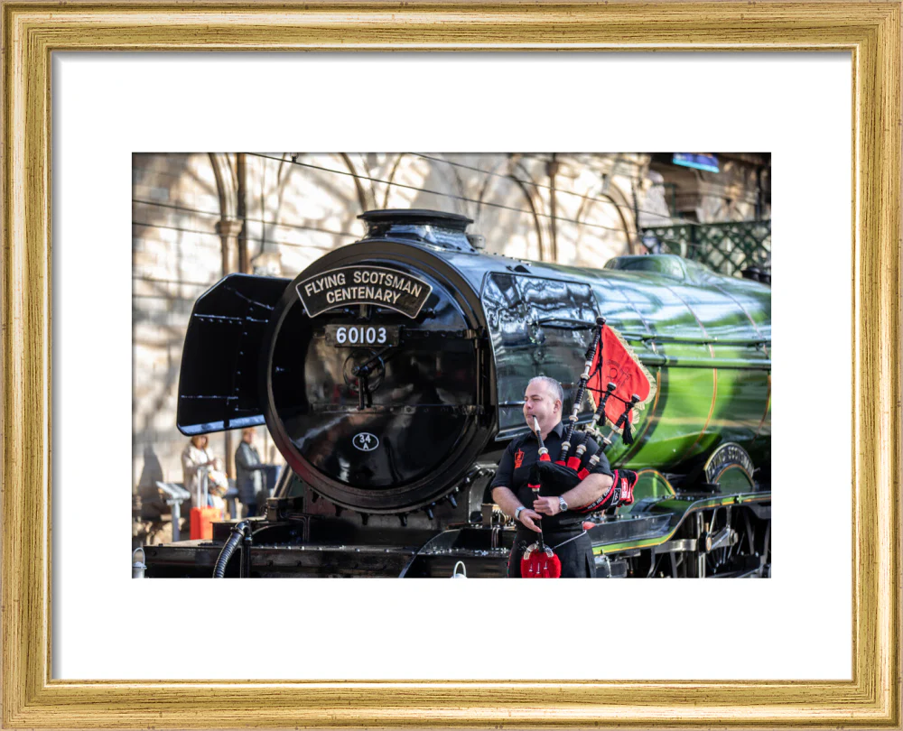 Kevin MacDonald from the Red Hot Chilli Pipers beside Flying Scotsman. - Image 5