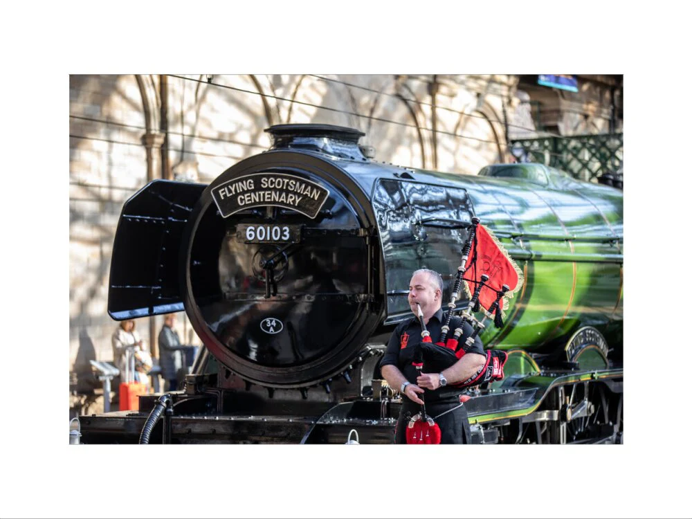 Kevin MacDonald from the Red Hot Chilli Pipers beside Flying Scotsman. - Image 7