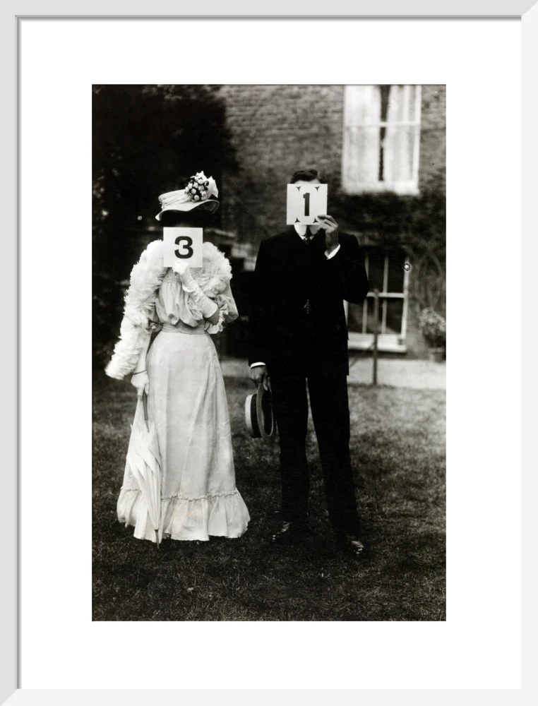 A couple, each holding up a number in front of their face circa 1905 - Image 14