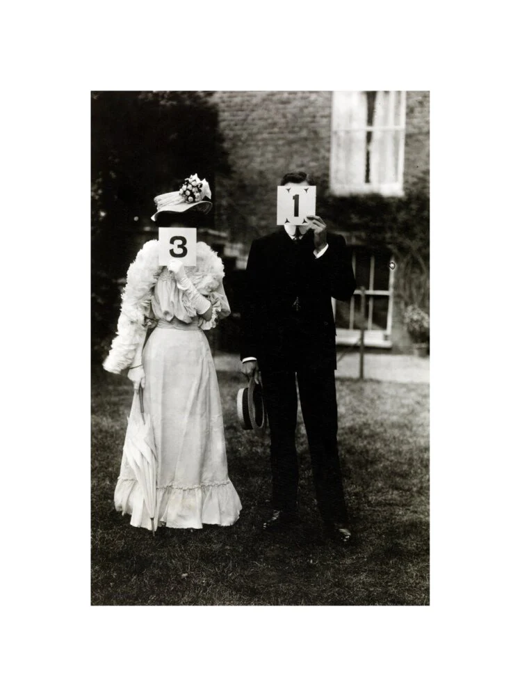 A couple, each holding up a number in front of their face circa 1905 - Image 27