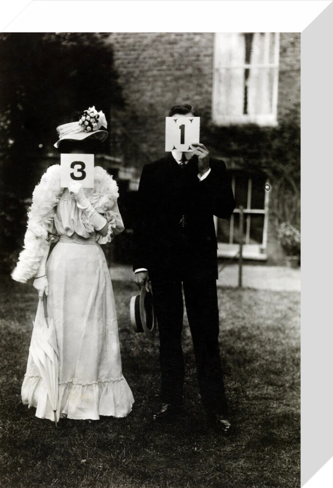 A couple, each holding up a number in front of their face circa 1905 - Image 31
