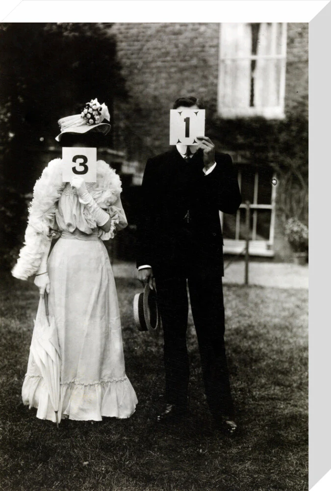 A couple, each holding up a number in front of their face circa 1905 - Image 32