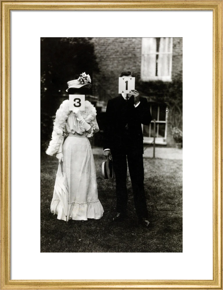 A couple, each holding up a number in front of their face circa 1905 - Image 48