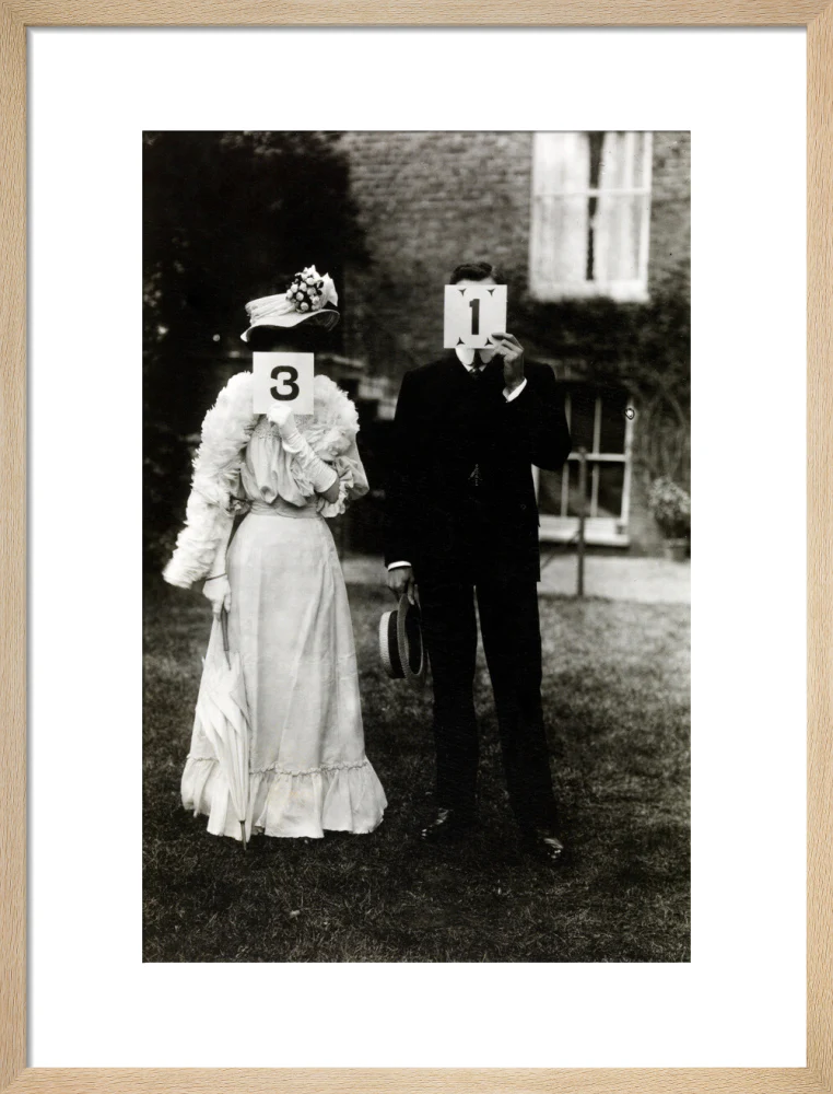 A couple, each holding up a number in front of their face circa 1905 - Image 49