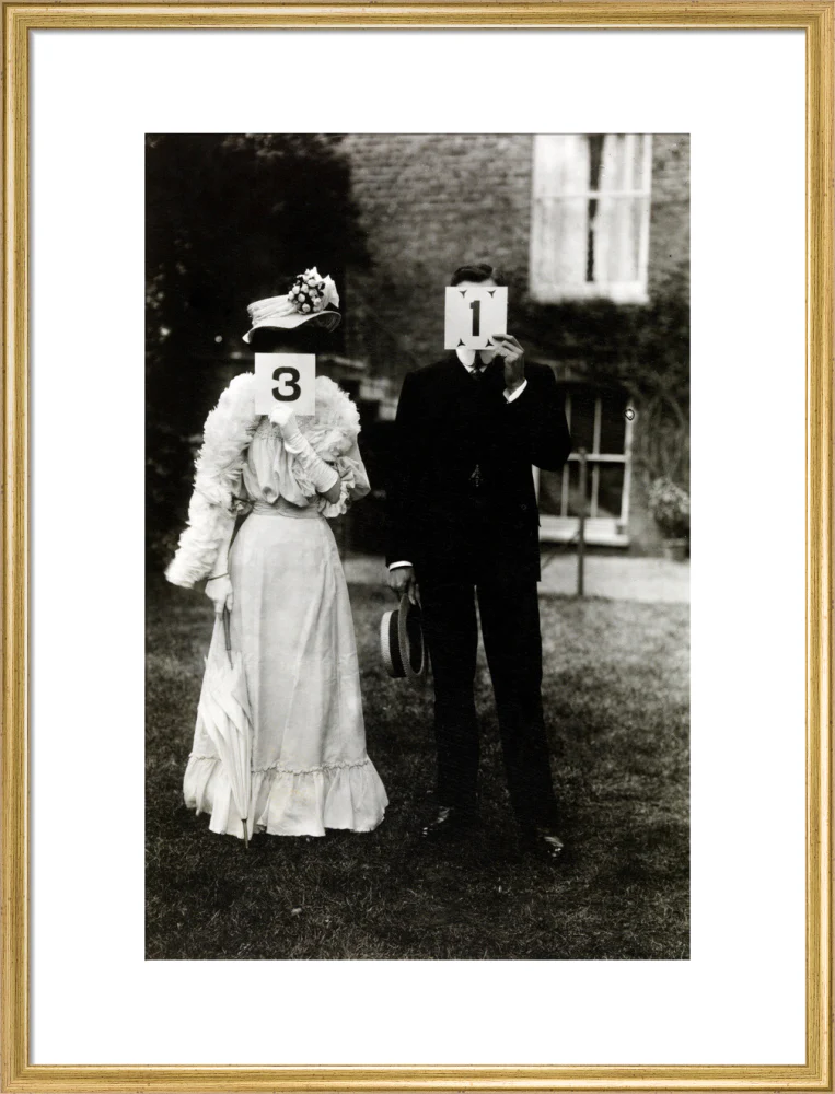 A couple, each holding up a number in front of their face circa 1905 - Image 53