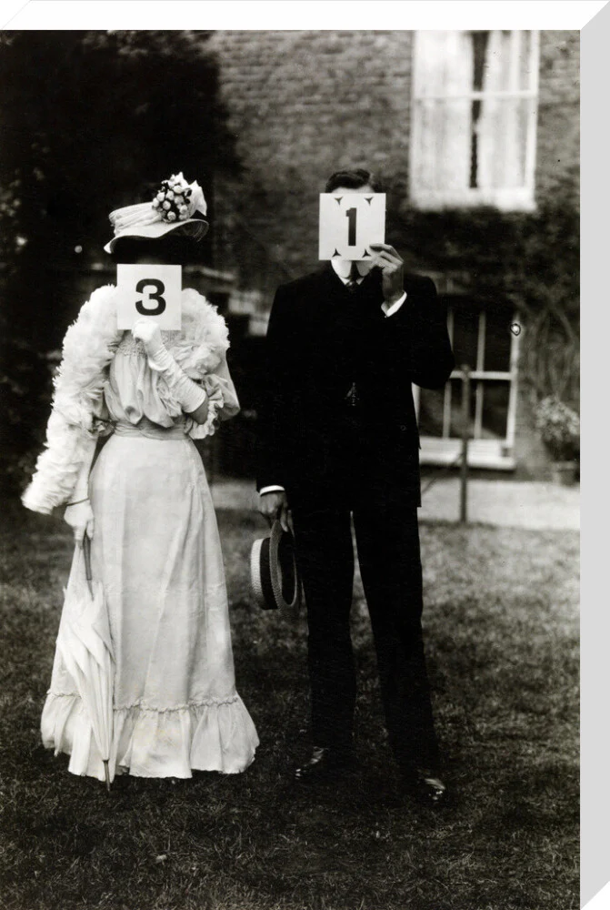 A couple, each holding up a number in front of their face circa 1905 - Image 66